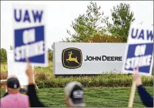  ?? AP ?? Members of the United Auto Workers strike outside a John Deere plant, Wednesday in Ankeny, Iowa. About 10,000 have gone on strike against John Deere since last Thursday in Iowa, Illinois and Kansas.