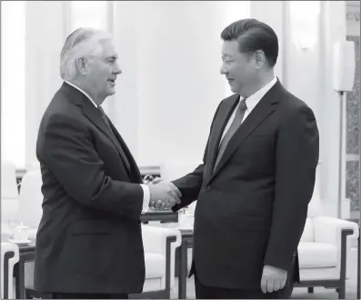  ??  ?? Chinese President Xi Jinping shakes hands with visiting US Secretary of State Rex Tillerson on Sunday in Beijing.