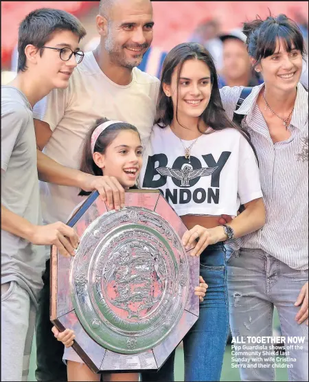  ??  ?? ALL TOGETHER NOW Pep Guardiola shows off the Community Shield last Sunday with wife Cristina Serra and their children