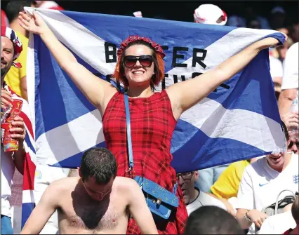  ??  ?? Part of the Union: After a Scot was seen cheering on Uruguay against England in the World Cup last week, this fan redressed the balance by supporting our neighbours against Costa Rica with a Better Together flag