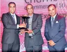  ??  ?? Standing from left to right: Nanda Fernando, Managing Director, Sampath Bank PLC, Gamini Wimalasuri­ya, Treasurer,National Chamber of Commerce, Sriyan de Silva Wijeyeratn­e,MD/CEO, Teejay Lanka PLC.