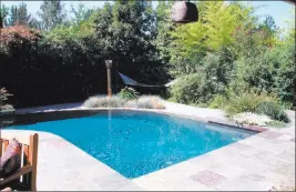  ?? Maureen Gilmer ?? Tribune News Service Naturally tall shrubs, bamboo and evergreen background trees screen the pool and the separate hammock for private rest and reflection.