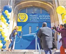  ?? KIMBERLY PAYNTER/WHYY ?? Kelly Espinosa, principal of Fanny Jackson Coppin Elementary School in Philadelph­ia, reveals the new sign at the school’s renaming ceremony on Tuesday.