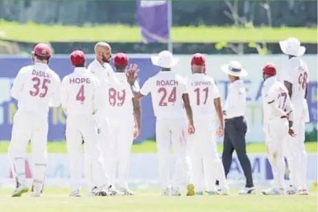  ?? ?? West Indies players celebratin­g the fall of a wicket during the second Test match against hosts Sri Lanka yesterday at the Galle Internatio­nal Stadium