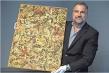  ?? MARK HENLE, THE ARIZONA REPUBLIC ?? Josh Levine holds a Jackson Pollock painting, a piece of art he says could fetch $10 million when it goes to auction.