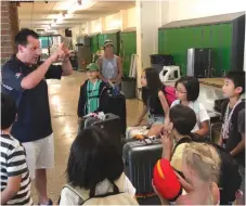  ??  ?? Arron Dobrescu tells his Japanese students to speak English only, keep their rooms clean and write in their journals daily while staying with their host families, during a pizza party on Aug. 1 to welcome the youths to Moose Jaw. Photo by Jason G. Antonio