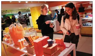  ?? AP/MARK LENNIHAN ?? Shoppers browse at a store in New York on April 10. Retail sales in March showed strong growth, rising the most since September 2017, while jobless claims fell to the lowest number since September 1969.