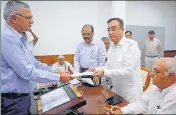  ?? KESHAV SINGH/HT ?? Haryana Congress candidate Ajay Makan and BJP nominee Krishan Lal Panwar (right) filling their nomination papers for the Rajya Sabha polls at the Haryana vidhan sabha in Chandigarh on Tuesday.