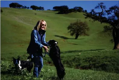  ?? PHOTOS BY ARIC CRABB — BAY AREA NEWS GROUP ?? Real estate agent Danielle Davenport plays with her dogs in January on a rural property she is managing the sale of in Santa Clara County. Davenport specialize­s in commercial, agricultur­e, farm and ranch land real estate transactio­ns.