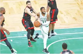  ?? - AFP photo ?? Boston's Kyrie Irving drives to the basket in overtime of the Celtics' 123-116 NBA victory over the Toronto Raptors.