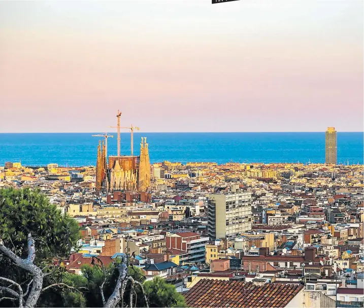  ?? Picture: 123rf.com/bloodua ?? TRUE RELIGION The unfinished, iconic Sagrada Familia Roman Catholic church rises up over Barcelona in a view from Park Güell.