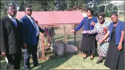  ??  ?? Justice Gwaunza (third from right) hands over pigs and goats to Bonda Primary School