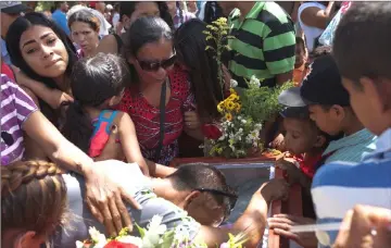  ??  ?? Mourners grieve during the funeral of Alexis Rodriguez, one of the inmates who died during a riot and a fire in the cells of the General Command of the Carabobo Police, at a cemetery in Valencia, Venezuela. — Reuters photo