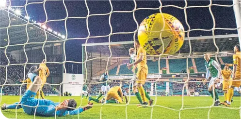  ??  ?? Ryan Porteous’ header finds the net past Livingston keeper Liam Kelly to equalise for Hibs at Easter Road