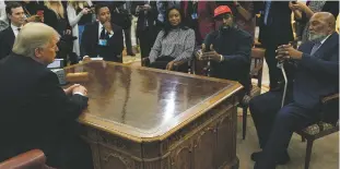  ?? PHOTOS BY EVAN VUCCI/ASSOCIATED PRESS ?? ABOVE: President Donald Trump meets Thursday with rapper Kanye West, in red cap, and former football player Jim Brown, in the Oval Office of the White House. BELOW: West smiles as he talks with the president during the meeting where the rapper repeatedly used vulgar language.