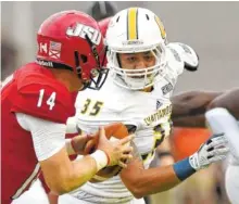  ?? STAFF FILE PHOTO BY ROBIN RUDD ?? UTC’s Michael Bean (35) pressures Jacksonvil­le quarterbac­k Bryant Horn (14) during the season opener. Bean made his first start in last week’s win at Samford, but he has been a steady contributo­r in his two seasons with the Mocs.