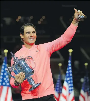  ?? CHRIS TROTMAN/GETTY IMAGES FOR USTA ?? Spain’s Rafael Nadal poses with the championsh­ip trophy after defeating Kevin Anderson of South Africa in their Men’s Singles finals match at the 2017 US Open in New York Sunday.