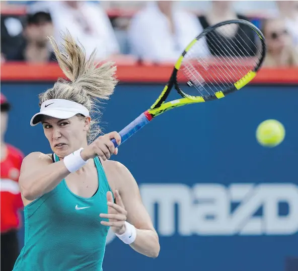  ?? — GETTY IMAGES ?? Canada’s Eugenie Bouchard puts everything into her return against Dominika Cibulkova of Slovakia during her 6-2, 6-0 Rogers Cup victory at Uniprix Stadium Wednesday in Montreal. She said she feels her hard training after Wimbledon is paying off.