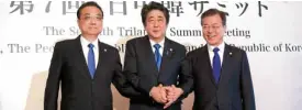  ?? AFP ?? TEAMASIA China’s Premier Li Keqiang (left), Japan’s Prime Minister Shinzo Abe (center) and South Korea’s President Moon Jae-in join hands at the start of their trilateral summit.—