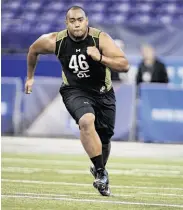  ?? Michael Conroy / Associated Press ?? Amini Silatolu, running a drill at the NFL combine, began his career at San Joaquin Delta College.