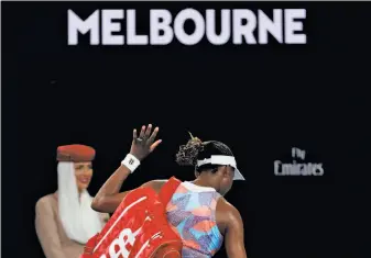  ?? Vincent Thian / Associated Press ?? Venus Williams leaves the arena after a first-round loss to Belinda Bencic. The elder Williams sister has won seven Grand Slam singles titles, 16 fewer than her record-setting sister.