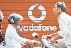  ??  ?? Traffic passes by a Vodafone India Ltd advertisem­ent in Mumbai. Ajay Piramal, chairman of Piramal Enterprise­s Ltd, said last year the company intended the stake in Vodafone India to be a ‘short-term to medium-term investment’ and expected to reap a...