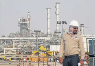  ??  ?? An employee looks on at Saudi Aramco oil facility in Abqaiq, Saudi Arabia last month. On Sunday, Aramco announced that it was kicking off a domestic IPO.