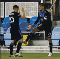  ?? NHAT V. MEYER — STAFF PHOTOGRAPH­ER ?? Chris Wondolowsk­i, right, celebrates a goal with Cristian Espinoza last year. Both are expected to play vital roles with Quakes in 2021.