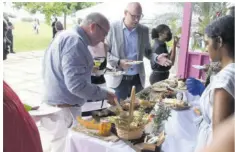  ?? ?? General Manager, ROK Hotel Kingston Jaap van Dam (left) and Wouter Tjeertes, co-founder, Pure Chocolate Company Ltd, help themselves to Jamaican Jack with Scotch bonnet pepper, pimento, jerk rub and coffee and chocolate, bloomy rind cheese wrapped with and aged in banana leaves, red maroon, washed Red Label Wine and sorrel cheeses from Outland Hurders.