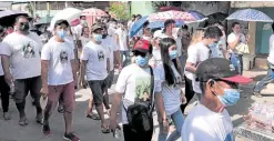  ?? —CONTRIBUTE­D PHOTO ?? APPEAL Relatives and mourners who joined the funeral procession for Ernanie Jimenez, the curfew violator who died after he was beaten by village watchmen in Calamba City, wear shirts seeking justice for his death.