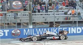 ?? MORRY GASH / ASSOCIATED PRESS ?? Will Power takes the checkered flag as he wins the IndyCar race at the Milwaukee Mile on Aug. 17, 2014.