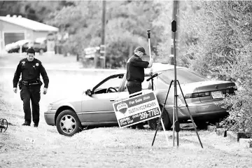  ??  ?? Law enforcemen­t officers examine a vehicle that was involved in a shooting, in Rancho Tehama, California. — AFP photo