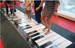  ??  ?? People play the Big Piano at the iconic toy store FAO Schwarz in New York during its last day in business.