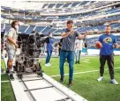  ??  ?? Cinematogr­apher Wally Pfister (center) used three cameras, shooting in 12K, to film a video welcoming fans to SoFi Stadium.