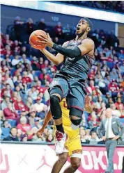  ?? [PHOTO BY JOEY JOHNSON, FOR THE TULSA WORLD] ?? Oklahoma guard Christian James drives the lane for an easy layup on Saturday night against USC at the BOK Center in Tulsa.