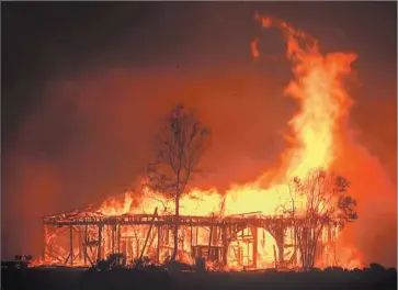  ?? Photograph­s by Kent Porter The Press Democrat ?? THE HISTORIC Round Barn burns in Santa Rosa, Calif. The Press Democrat’s staff headed to the newsroom in the late night and early morning hours. For the families of many of them, it became an evacuation center.