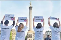  ?? AP PHOTO ?? People gesture as they attend a vigil in Trafalgar Square, London, Tuesday for the victims of the attack which killed over 20 people as fans left a pop concert by Ariana Grande in Manchester on Monday night.