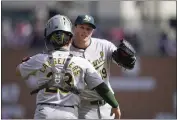  ?? CARLOS OSORIO — THE ASSOCIATED PRESS ?? A's pitcher Mason Miller hugs catcher Shea Langeliers (23) after the ninth inning of Saturday's game in Detroit.