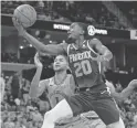  ?? BRANDON DILL/AP ?? Suns forward Josh Jackson (20) shoots against Memphis Grizzlies forward Kyle Anderson (1) in the first half of Saturday’s game in Memphis, Tenn.