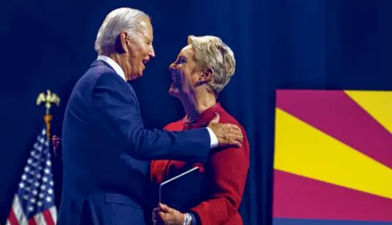  ?? JIM WATSON/AFP VIA GETTY IMAGES ?? President Biden embraced Cindy McCain, widow of Senator John McCain, as he arrived to deliver remarks on democracy at an event honoring the legacy of McCain at the Tempe Center for the Arts in Tempe, Ariz., on Thursday.