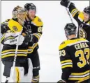  ?? Charles Krupa ?? The Associated Press Boston Bruins goaltender Tuukka Rask, left, is congratula­ted by teammates after the Bruins defeated the Toronto Maple Leafs in Game 7.