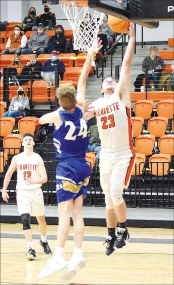  ?? Westside Eagle Observer/MIKE ECKELS ?? Senior Jake Carver (23) goes for a layup during the fourth quarter of the Gravette-Harrison boys contest in Gravette Friday night. Carver led the Lions with 23 points to take the conference win, 71-64, over the Goblins.