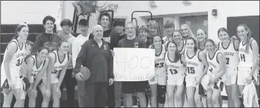  ?? Photo by Becky Polaski ?? Lady Crusader head coach Ken Pistner poses for a photo with his team and members of the student section as they celebrate his 400th career victory following Wednesday’s 49-19 win over Couderspor­t.