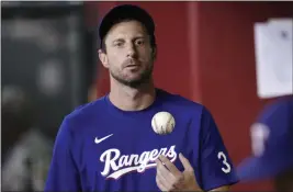  ?? ROSS D. FRANKLIN — THE ASSOCIATED PRESS ?? Texas Rangers right-hander Max Scherzer thinks Major League Baseball needs to look a lot deeper than a roster limit if it wants to return starting pitching to prominence.
