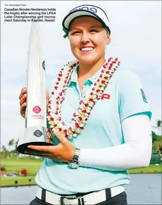  ?? The Associated Press ?? Canadian Brooke Henderson holds the trophy after winning the LPGA Lotte Championsh­ip golf tournament Saturday in Kapolei, Hawaii.