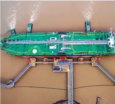  ??  ?? An oil tanker unloads crude at a terminal in Zhoushan, Zhejiang province, China