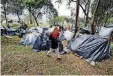  ?? [AP PHOTO] ?? Venezuelan migrants camp in a park near the main bus terminal in Bogota, Colombia.