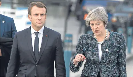  ?? Picture: AP. ?? Prime Minister Theresa May speaks to French President Emmanuel Macron as they walk on a pier at an EU summit in Gothenburg.