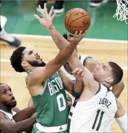  ?? AP photo ?? Boston Celtics’ Jayson Tatum shoots over Milwaukee Bucks’ Brook Lopez during the first half