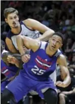  ?? RICK BOWMER — THE ?? Sixers forward Ben Simmons (25) and Utah Jazz center Tibor Pleiss ... uh, he’s the tall one ... were battling for a rebound in this NBA summer league game July 7 in Salt Lake City. The two are now teammates.